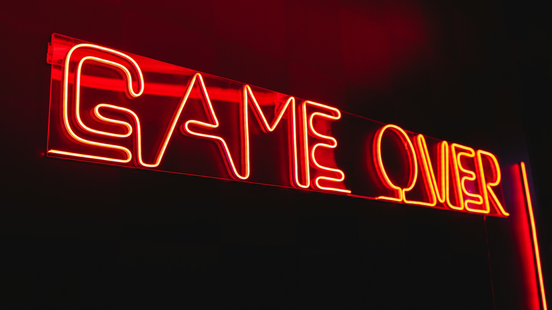 Neon light in a low light spelling out game over